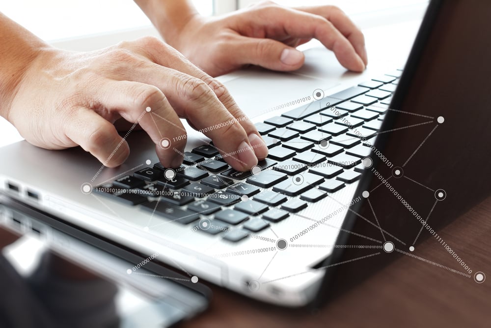 Close up of business man hand working on laptop computer with social network diagram on wooden desk as concept Close up of business man hand working on laptop computer with social network diagram on wooden desk as concept